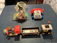 Overview of all three Fisher Price toys on table