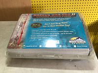 Factory clamshell case showing Rescue One SDE II information and Mountaineer Sports branding
