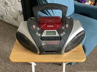 Front view showing RCA branding, digital radio display, cassette deck, speakers