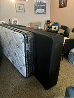Mattress and black box spring standing on side