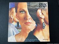 Front cover split-face artwork with Styx logo