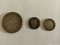 Obverse of three coins side-by-side showing dates 1962, 1891, 1944