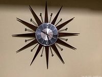 Front view of sunburst clock on wall