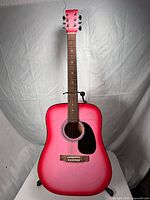 Front view of Mahar acoustic guitar showing red burst finish, rosette, bridge, pickguard and headstock