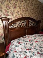 Queen headboard showing wood finish and iron scrollwork