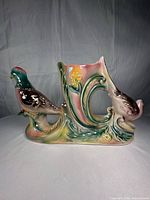 Profile of ceramic vase showing both pheasants and scroll detail
