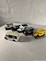 Group shot of six of the seven advertising vehicles showing scale and condition