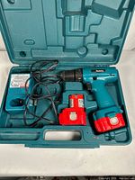 Drill with two batteries and charger inside molded case