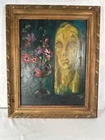 Frontal view of framed oil painting showing portrait and floral still life