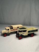 Both advertising trucks side by side showing overall design, colors and scale