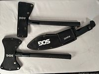 Three SOG edged tools in sheaths showing overall lot