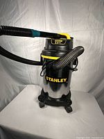 Full view of Stanley wet/dry vacuum with hose and rolling base