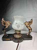 Front view showing rams, shade, base and cord