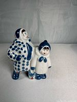 Full view of figurine showing mother and child in blue-white attire