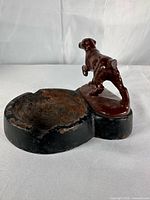 top view of cast iron ashtray and dog figure showing overall form