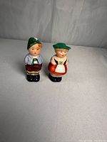 Front view of ceramic boy and girl shakers