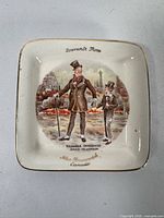 Front of Micawber plate showing scene, gold rim, souvenir text