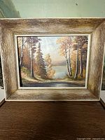 Full view of framed painting on display surface