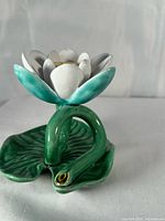 Front view showing lotus flower, snake stem, lily pad base