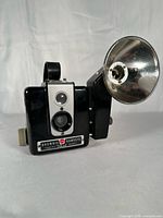 Front view of camera with attached flash unit