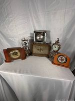 Group shot showing all five mantel and desk clocks
