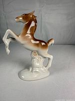 Left side profile of porcelain horse on pedestal base