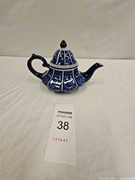 Full view of teapot front with lid on showing profile