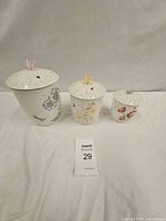 Front view of three Lenox Butterfly Meadow canisters with lids