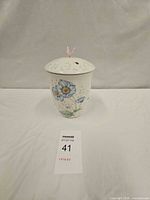 Front view of one Lenox Butterfly Meadow canister with lid on