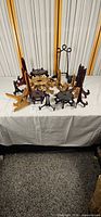 Group of assorted wood and metal display stands on table