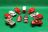 Group shot of all ten Coca-Cola diecast vehicles arranged on green background