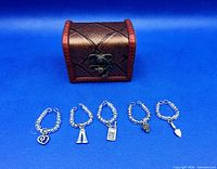 Front view of chest closed with five pewter charms displayed