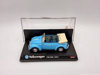 Front and side view of blue 1951 Volkswagen VW1200 diecast in display case