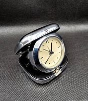 Clock open showing dial and case