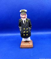 Front view of carved ship captain figurine