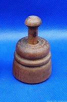 Front view of complete wooden butter stamp showing handle and body