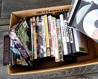 Box of assorted DVDs and VHS tapes