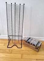 Front view of black metal CD rack stand and box of 28 CDs