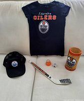 All five Oilers items – T-shirt, cap, mini stick, mini mug, bamboo stein