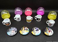 Overall view of five mini mugs, five capsule containers, and four ROXX discs