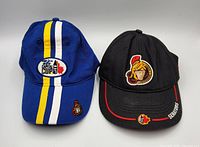Front view of both caps showing logos, colors, visor details