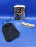 Hand warmer, fuel container and pouch displayed together