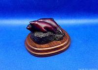 Front angled view of three-seal figurine on wood base