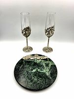 Front view of marble cheese board and two champagne flutes