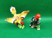 Front view of both porcelain woodpecker figurines