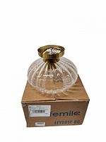 Lamp on top of original Femilo box showing glass shade and brass mount