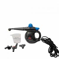 Handheld steam cleaner with all included accessories laid out