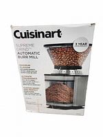 Front of boxed Cuisinart Supreme Grind Automatic Burr Mill coffee grinder showing product image and features