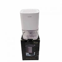 Front view of white compact dehumidifier sitting on its retail box