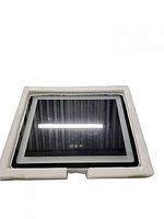 Mirror lying flat in foam packaging showing illuminated edge and three touch buttons